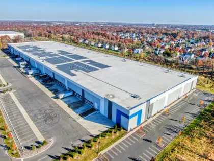 Distribution center with loading docks and a rooftop solar array from the air